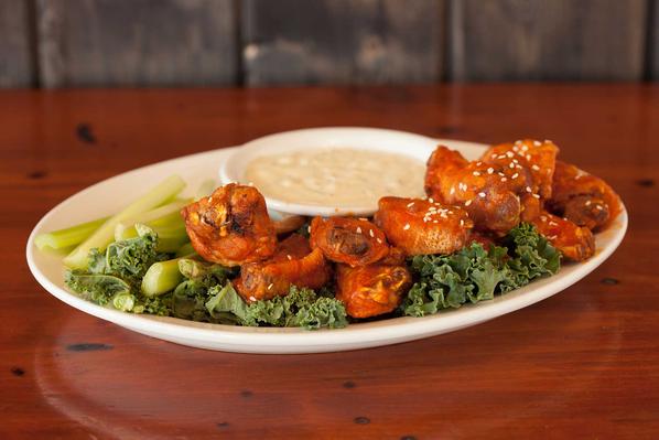 Spicy chicken wings on white plate